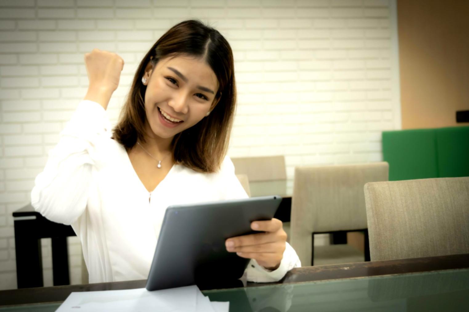 Person using banking application on laptop and mobile device simultaneously